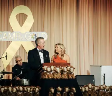 1. People speaking at a fundraising event for Camp One Step.