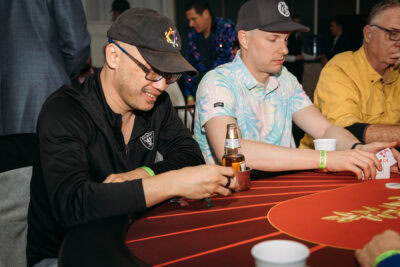 High-stakes poker game at Camp One Step charity event with enthusiastic players and vibrant atmosphere.