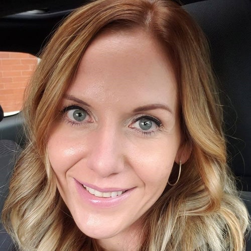 Bright smiling woman at Camp One Step autism camp, promoting inclusion and support for children with autism.