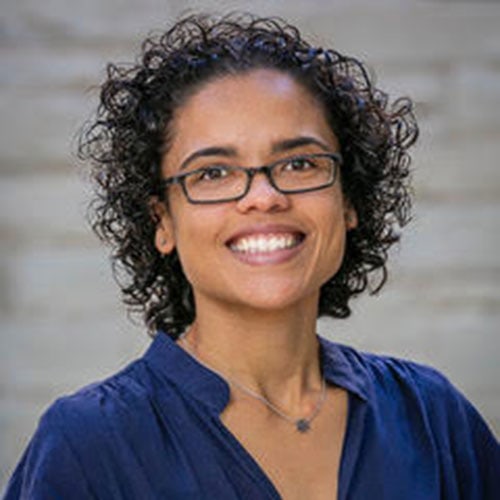 Smiling woman with glasses at Camp One Step outdoor retreat center.