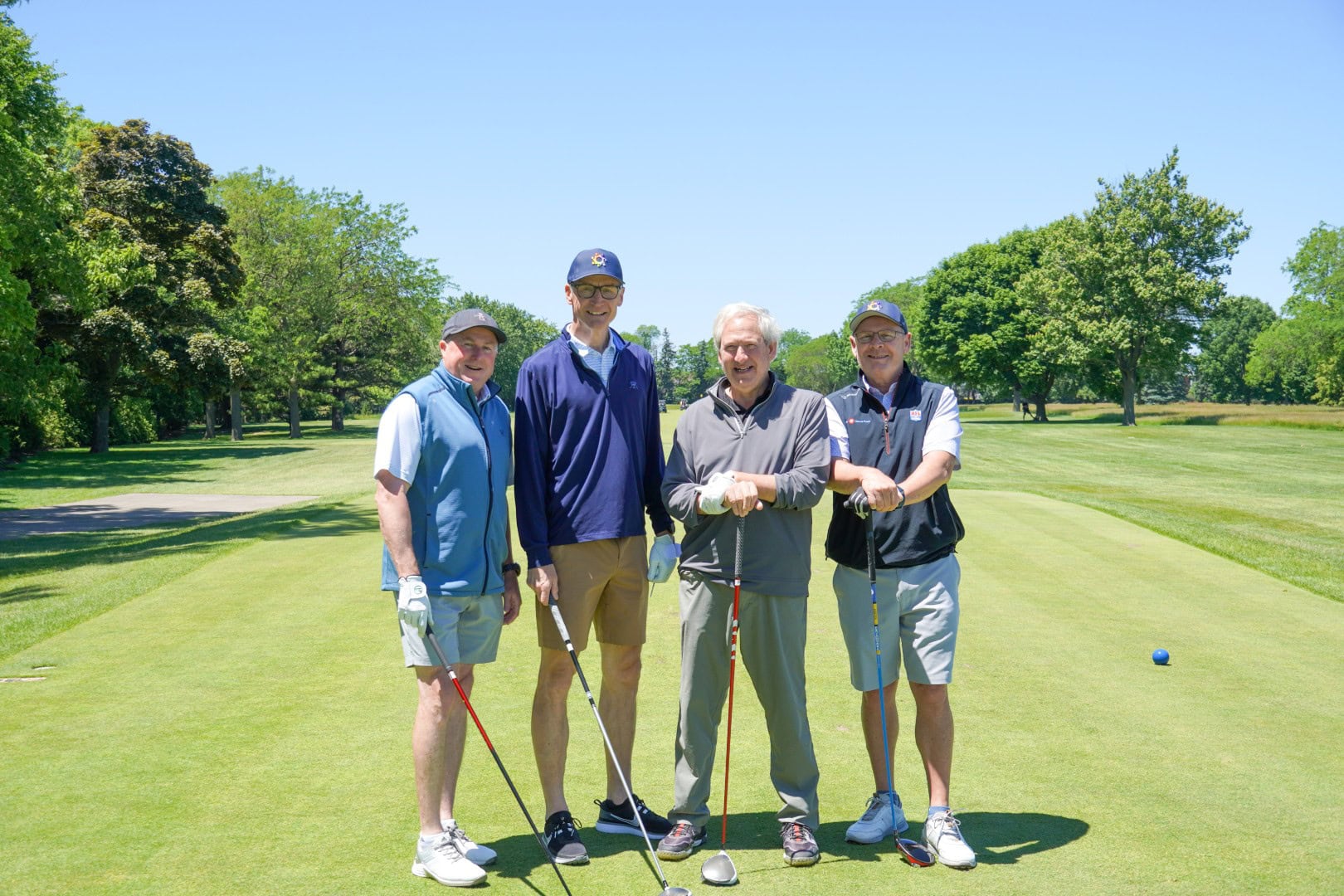 Senior golfers enjoying a game on the lush green golf course at Camp One Step.