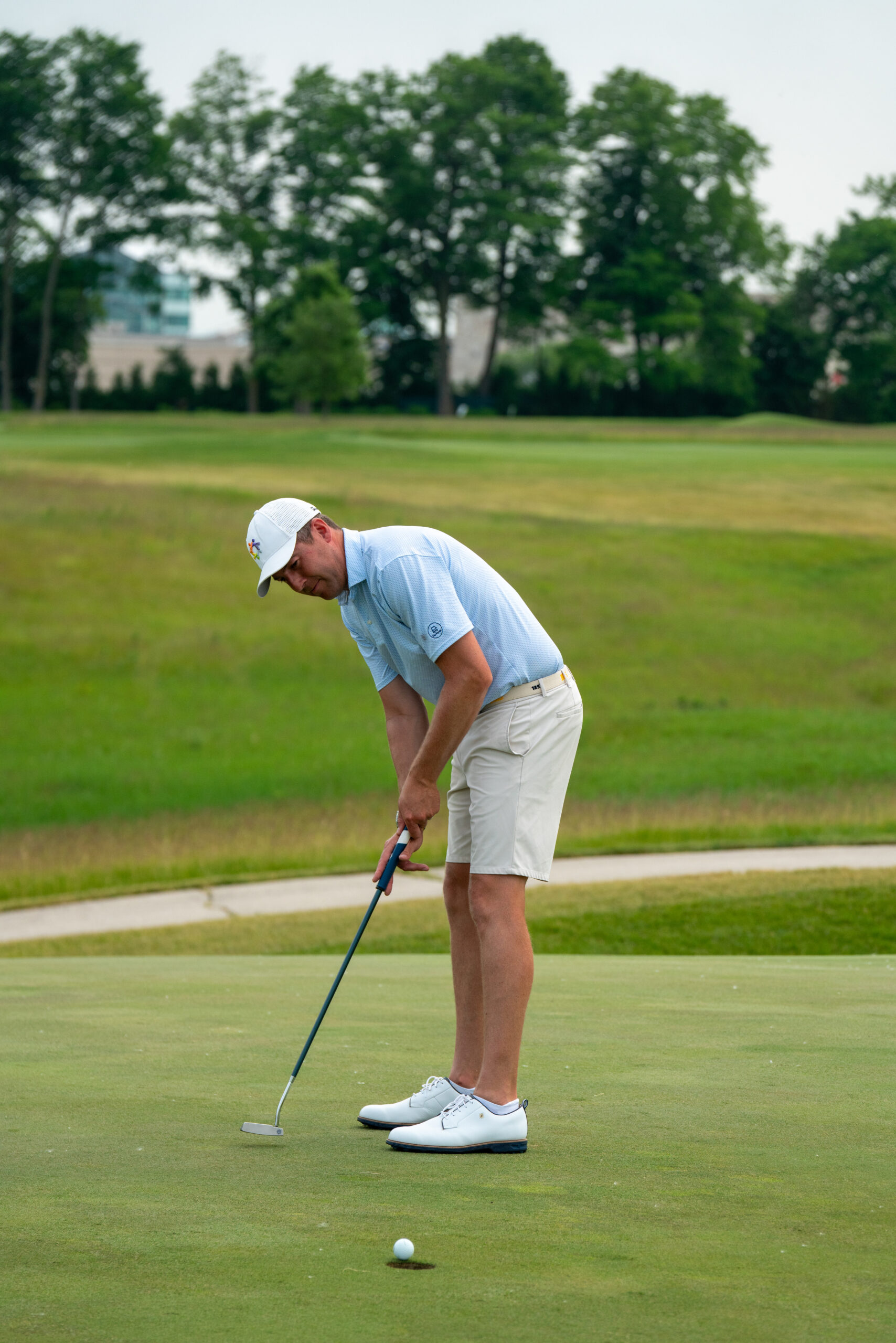 Golfer lining up putt on green