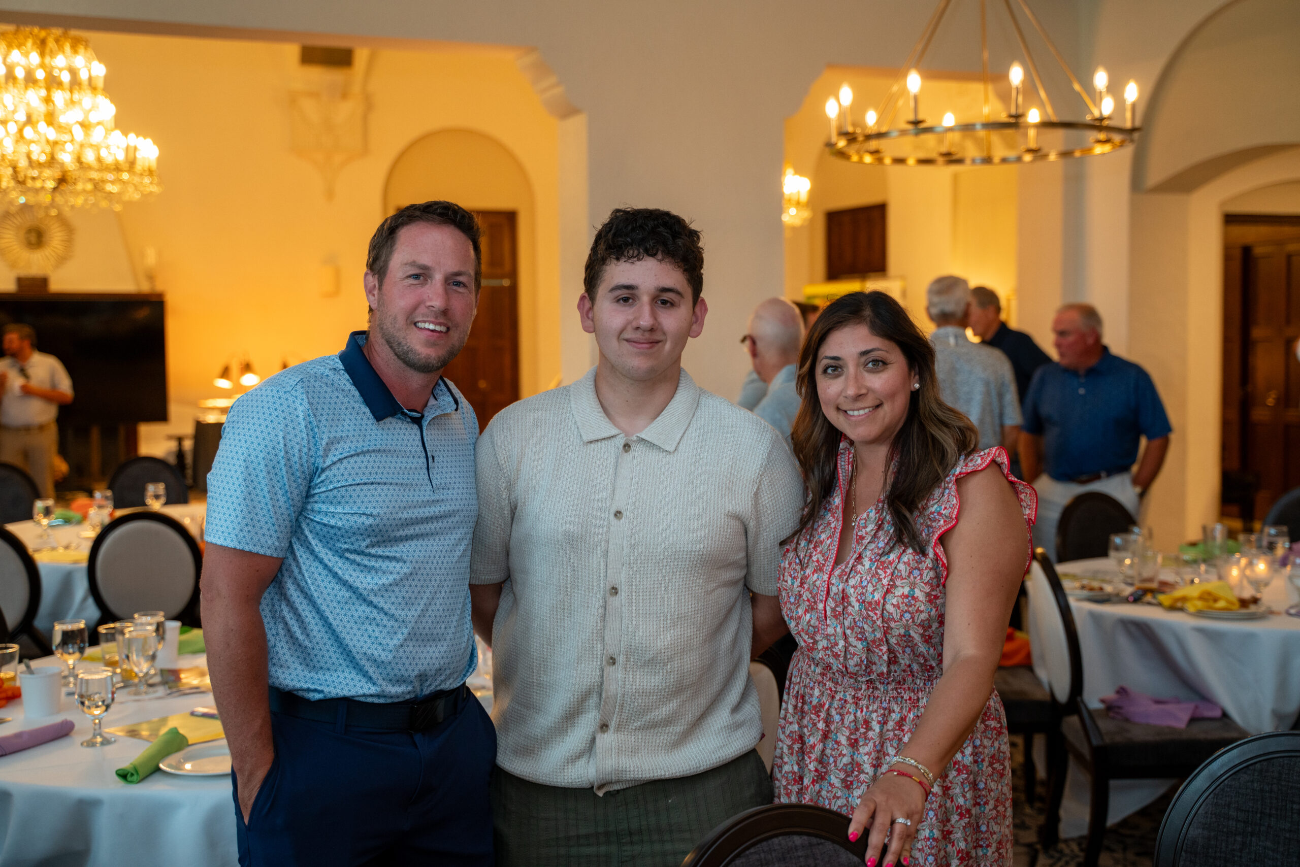 Three people posing at elegant banquet hall