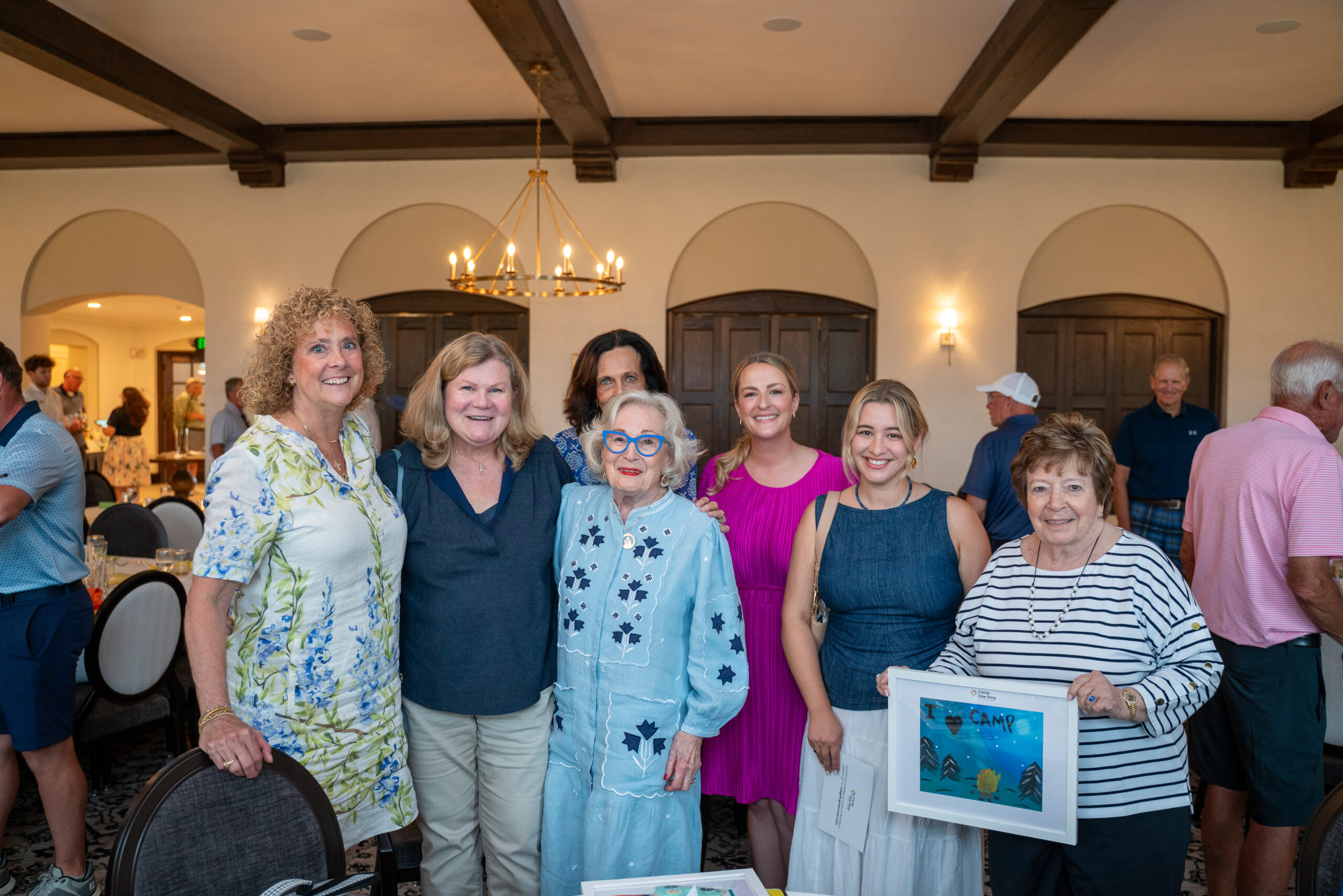 Group of women posing at indoor community event