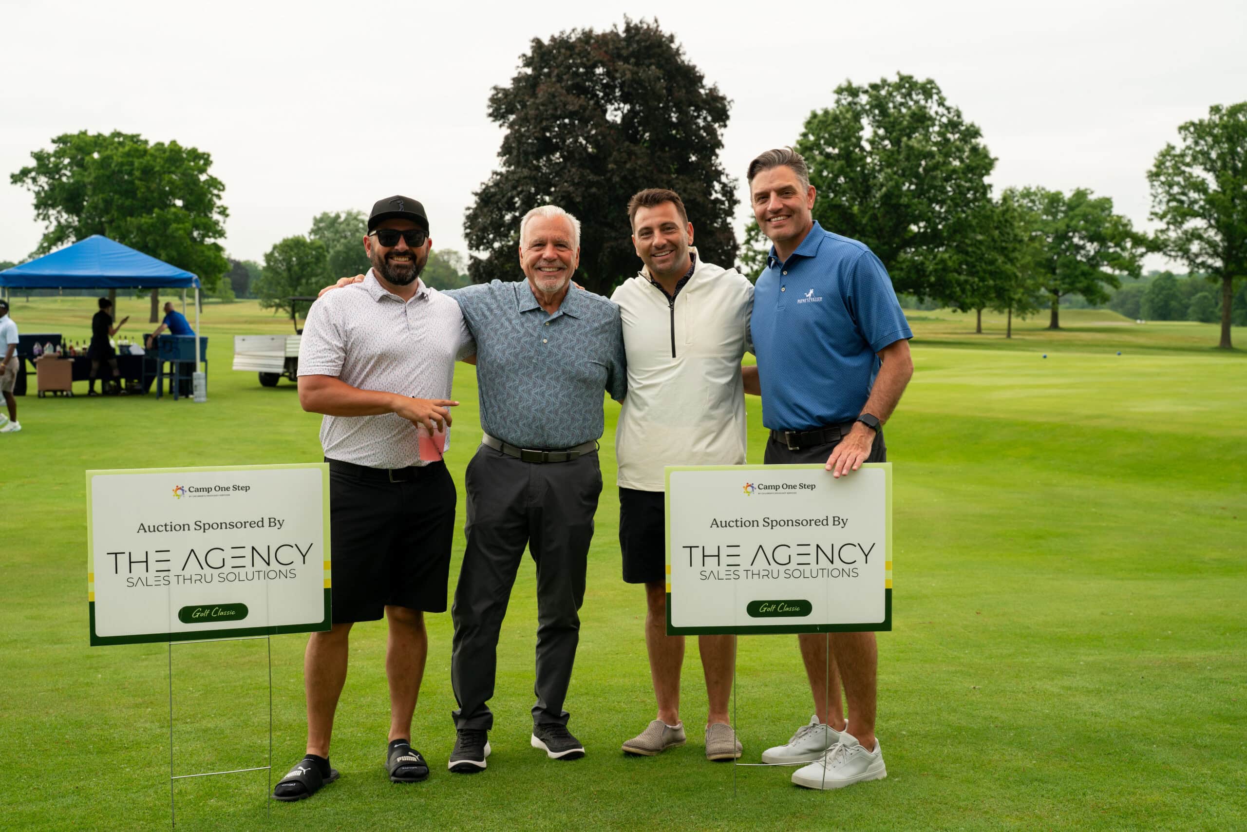 Four men posing at charity golf tournament