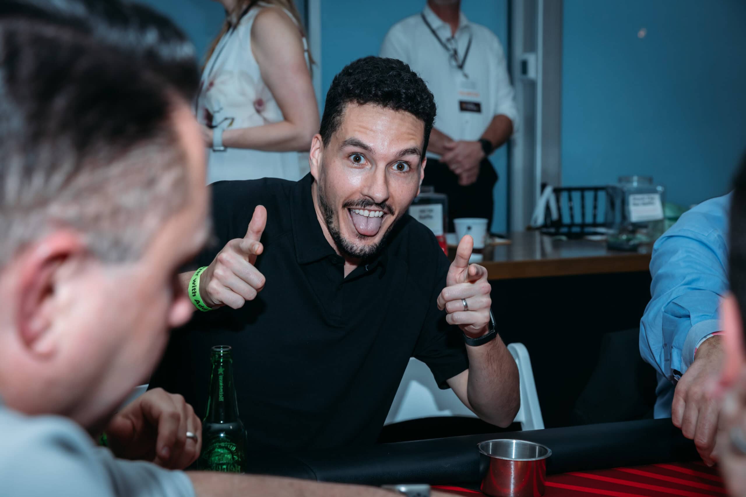Man playfully posing at a poker table.