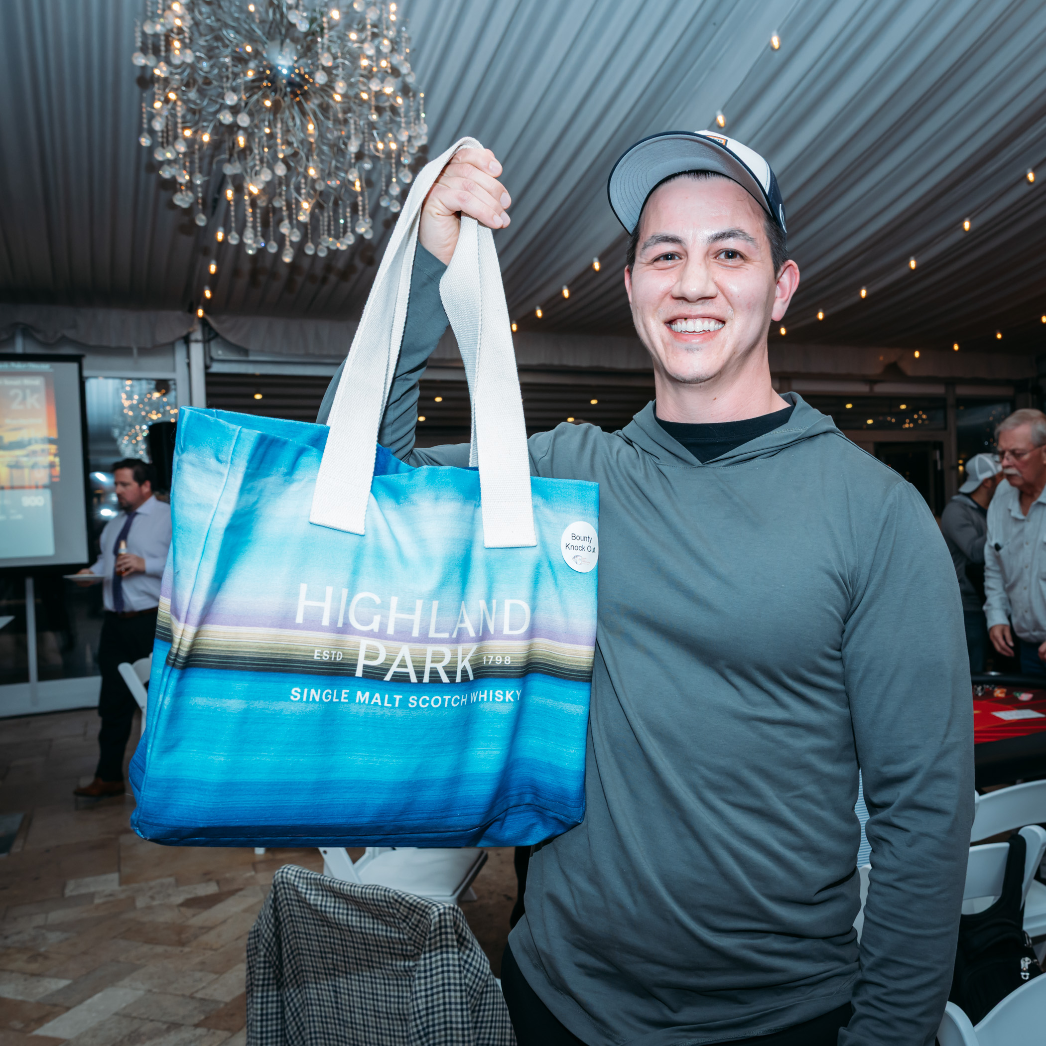 Man holding Highland Park tote bag