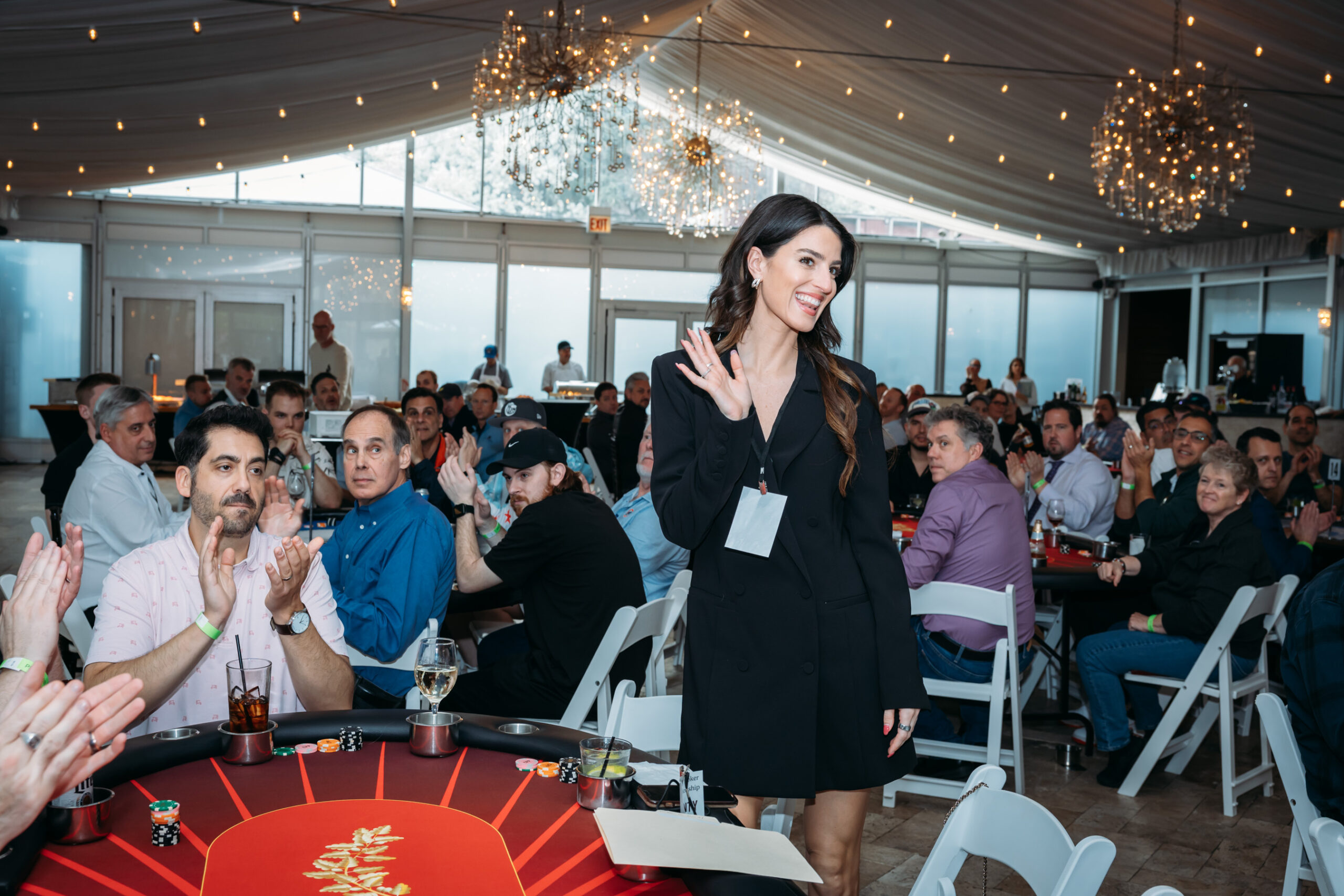 Woman waving at a poker event