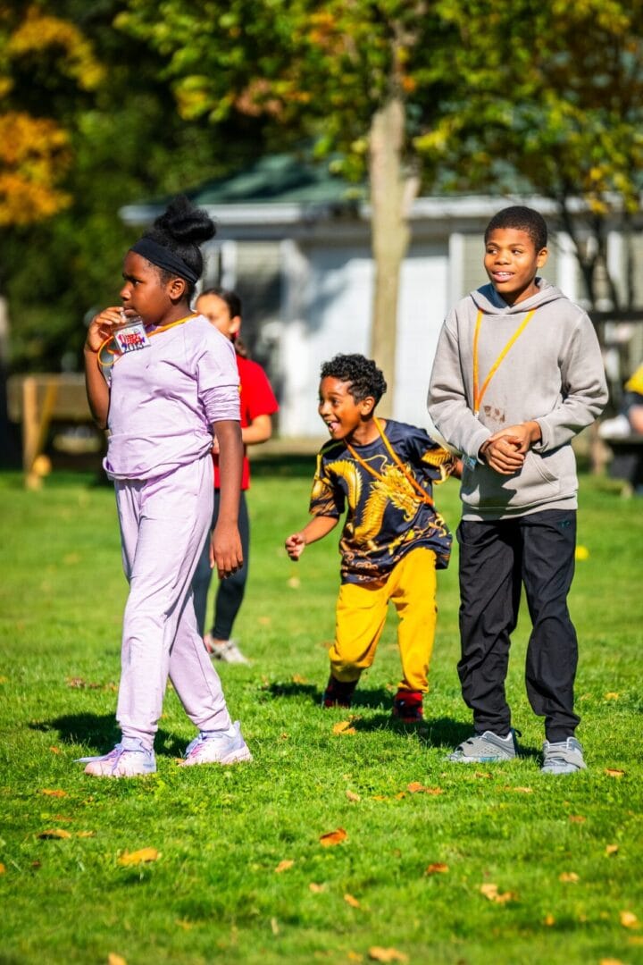 Kids enjoying outdoor activities at Camp One Step in vibrant fall scenery.