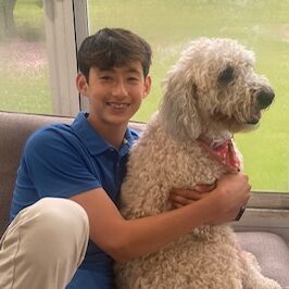 Girl hugging large poodle at Camp One Step.