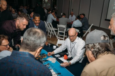 A lively group of people engaged in a team-building activity at Camp One Step event.