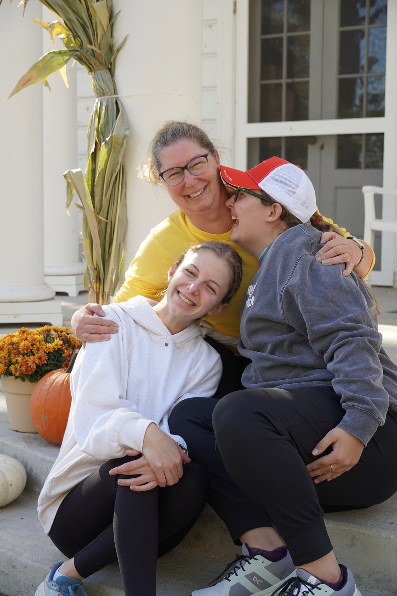 Joyful family hugging outside at Camp One Step event, celebrating community and outdoor fun.