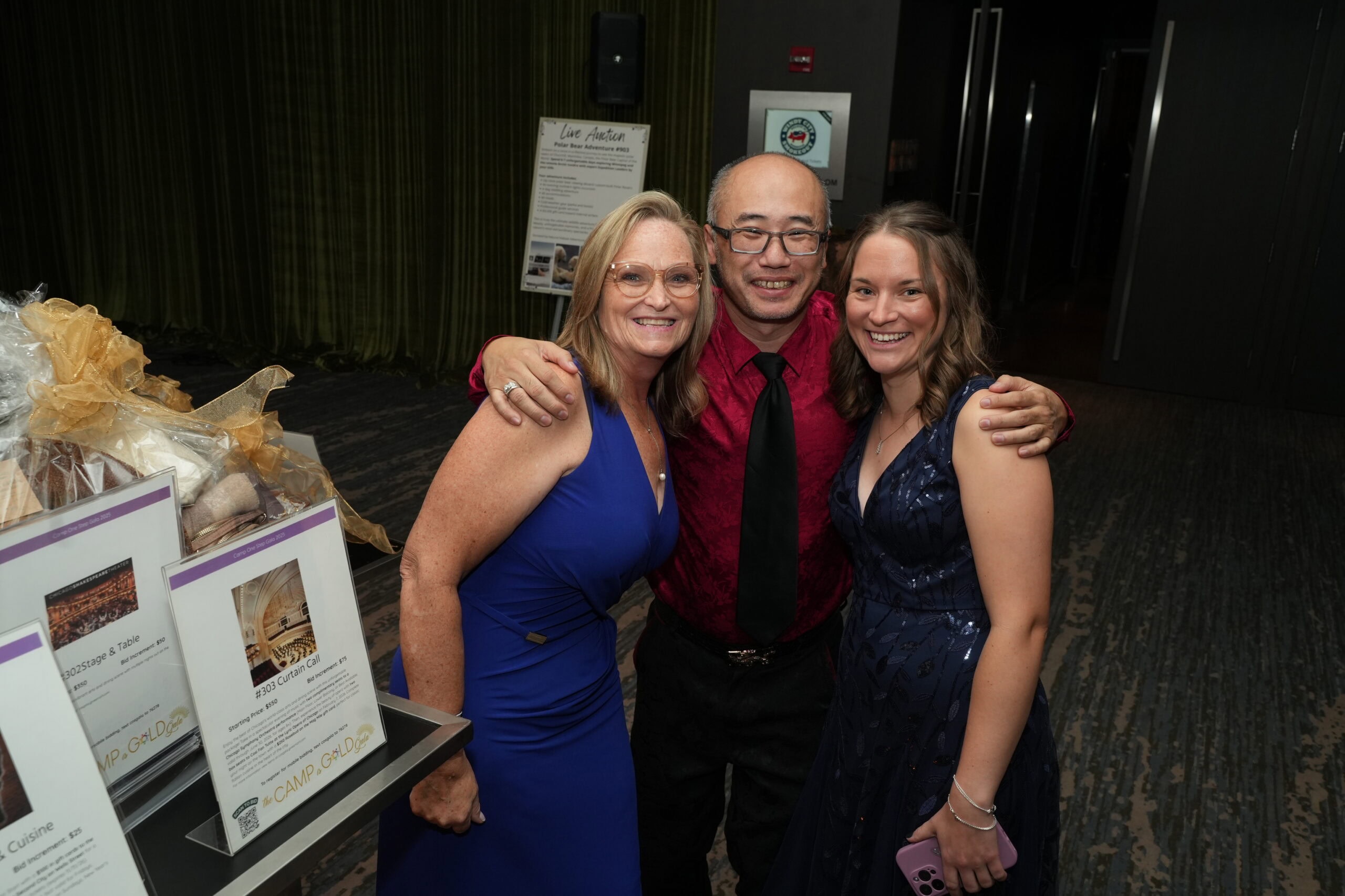 Smiling people enjoying a fundraising event at Camp One Step.