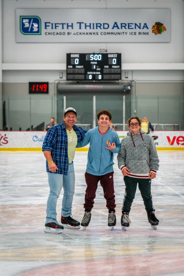 Smiling group on ice rink at Chicago Blackhawks arena, enjoying skating fun with family and friends.