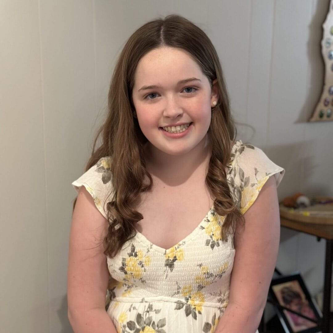 Smiling young girl at Camp One Step, outdoor adventure camp for children with cancer.