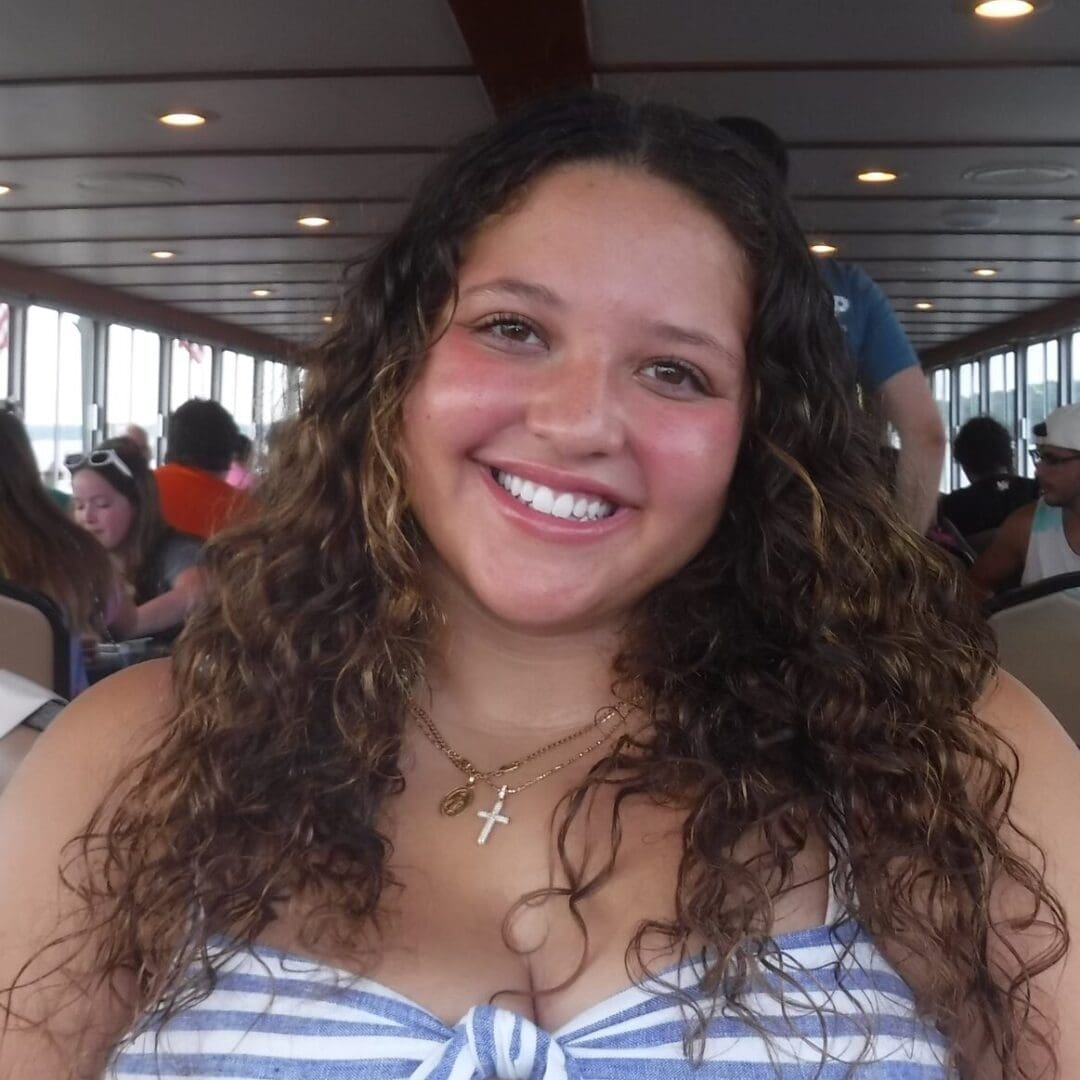 Smiling woman on cruise ship, enjoying family vacation at Camp One Step.