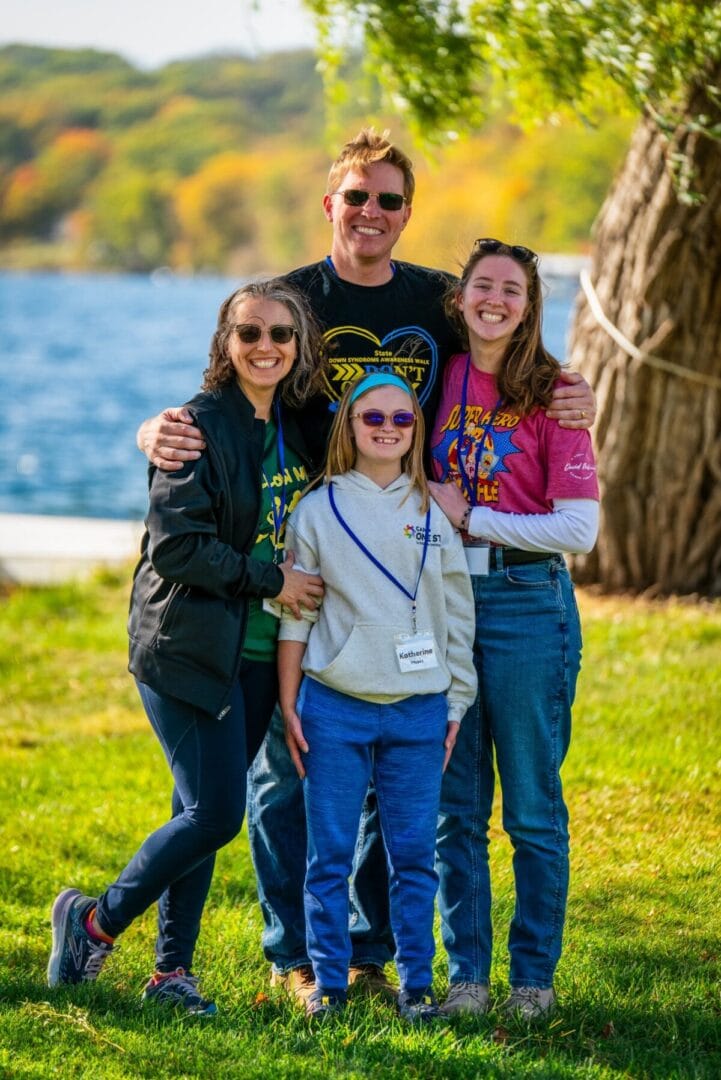 Outdoor family group at Camp One Step by the lake, enjoying a scenic fall day.