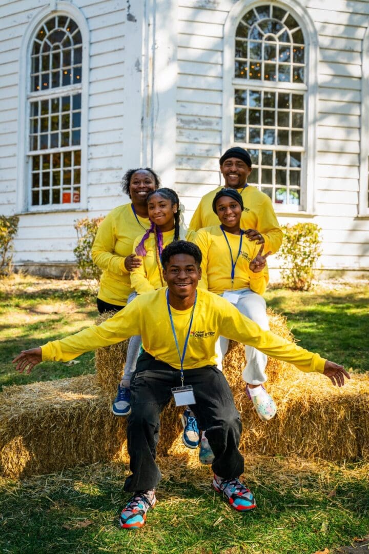 Smiling camp group in yellow shirts at Camp One Step outdoor event.