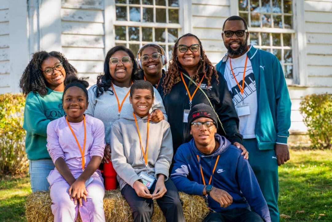 Empowered diverse group at Camp One Step outdoor camp, showing unity, joy, and team spirit.