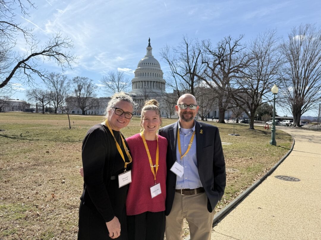 1. Group of people smiling outside the U.S. Capitol during daytime.