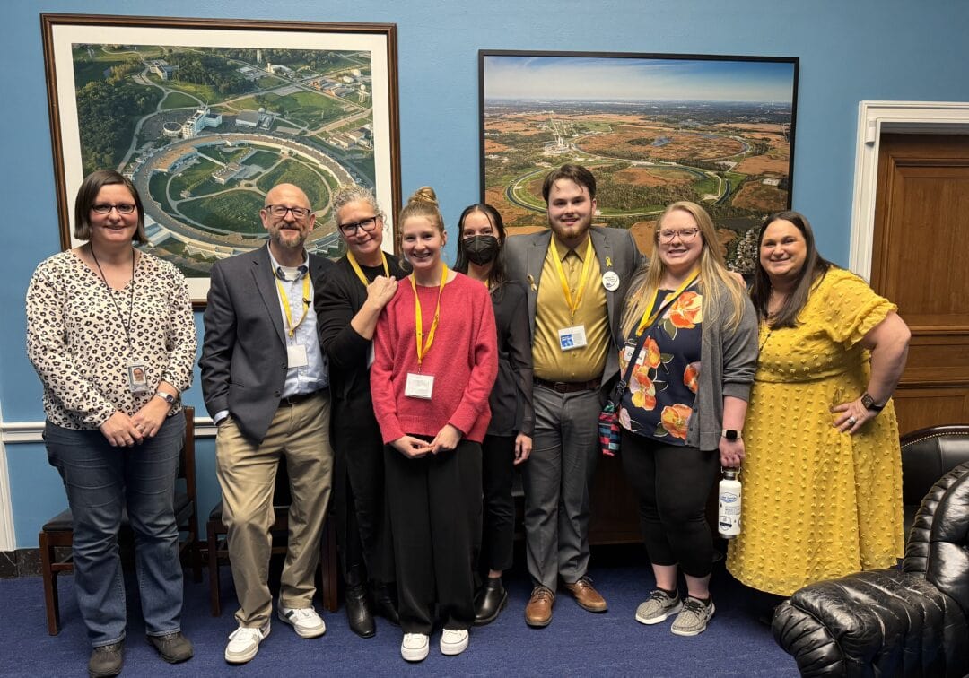 - Group of diverse people smiling at Camp One Step, a retreat for caregivers and families.