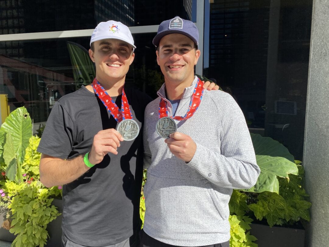 Smiling young men proudly display their medals after winning, showcasing the achievements celebrated at Camp One Step.