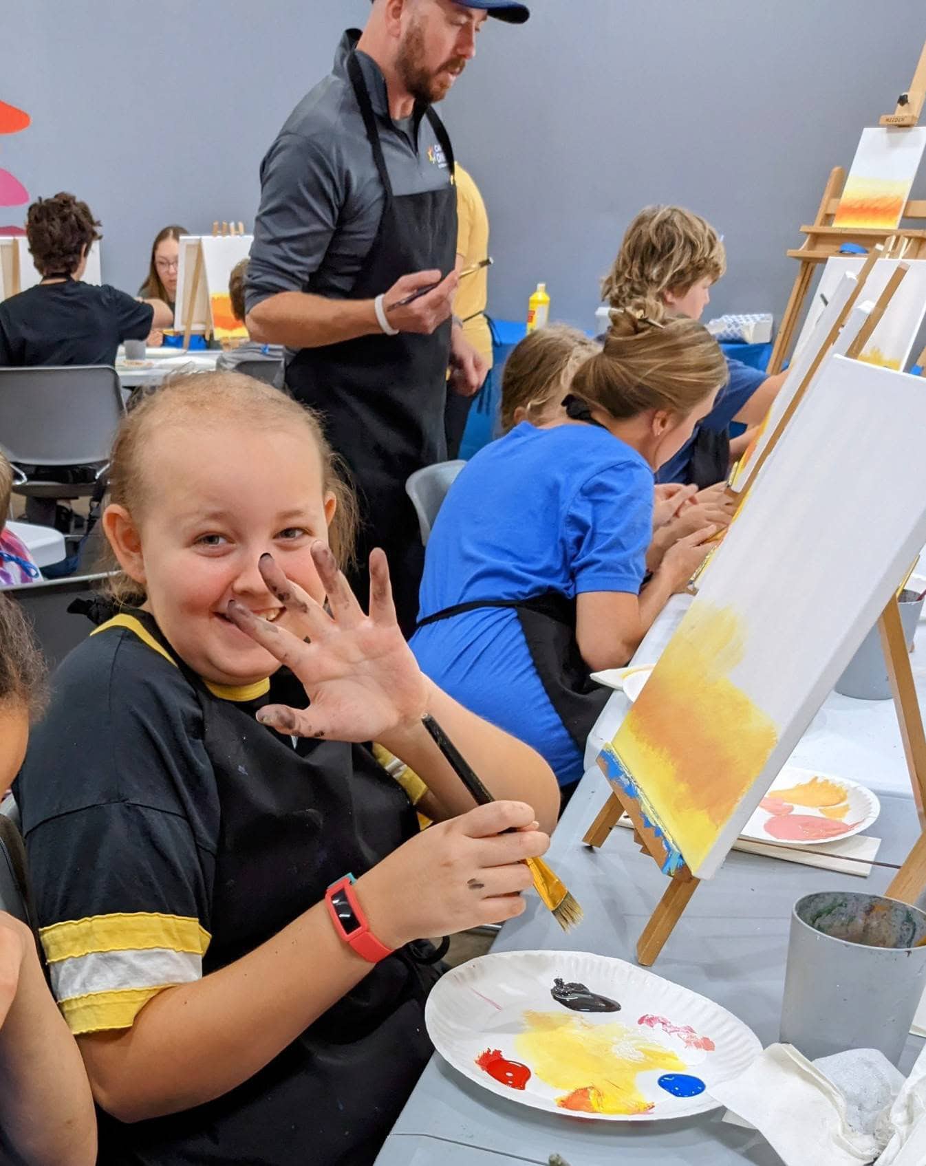 Kids painting art at Camp One Step, summer camp for children with cancer.