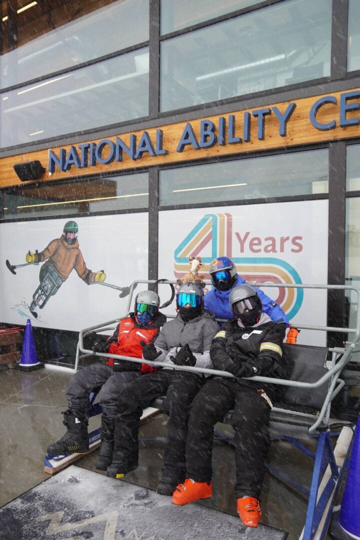 1. Adaptive skiing group outside National Ability Center during snowy weather.