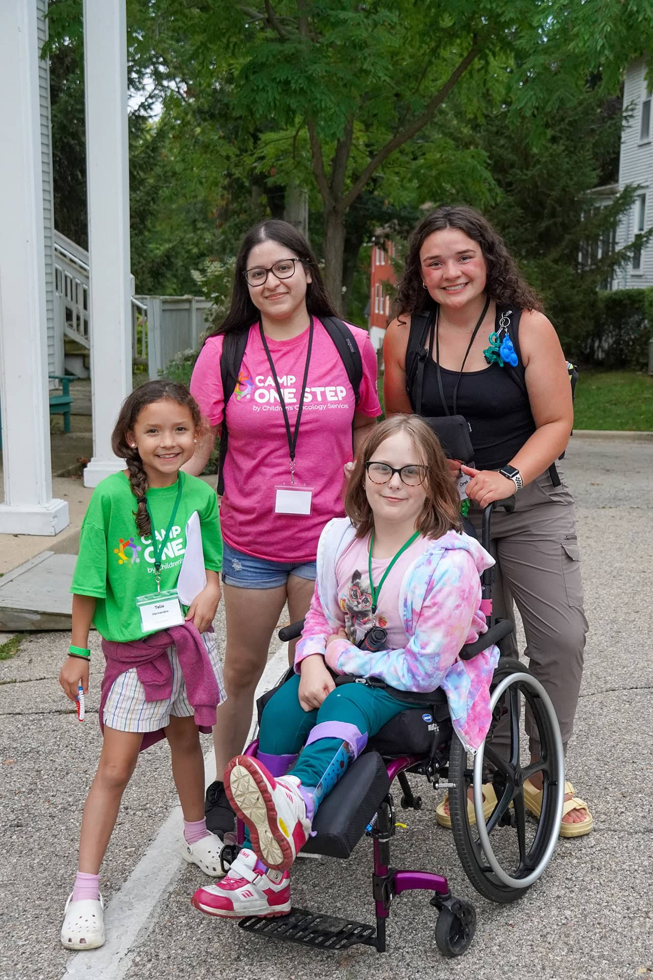 1. Children at Camp One Step with caregivers, outdoor setting, community support for children with disabilities.