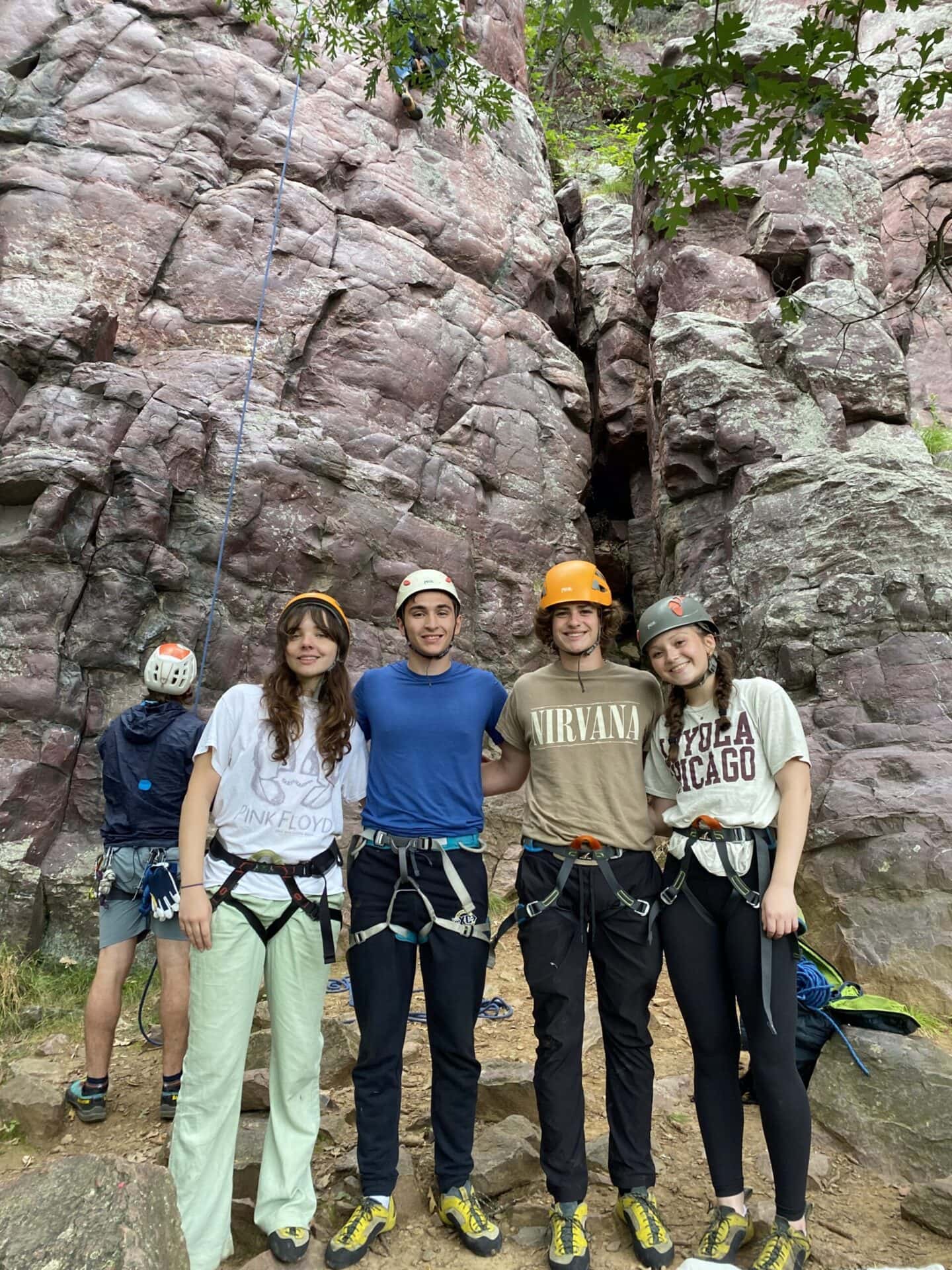 Climbing group at Camp One Step preparing for rock climbing adventure in the outdoors.