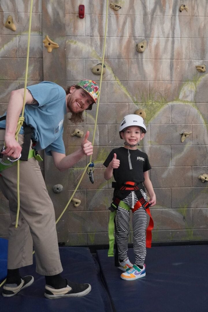 Climbing wall activity for kids at Camp One Step outdoor adventure camp.
