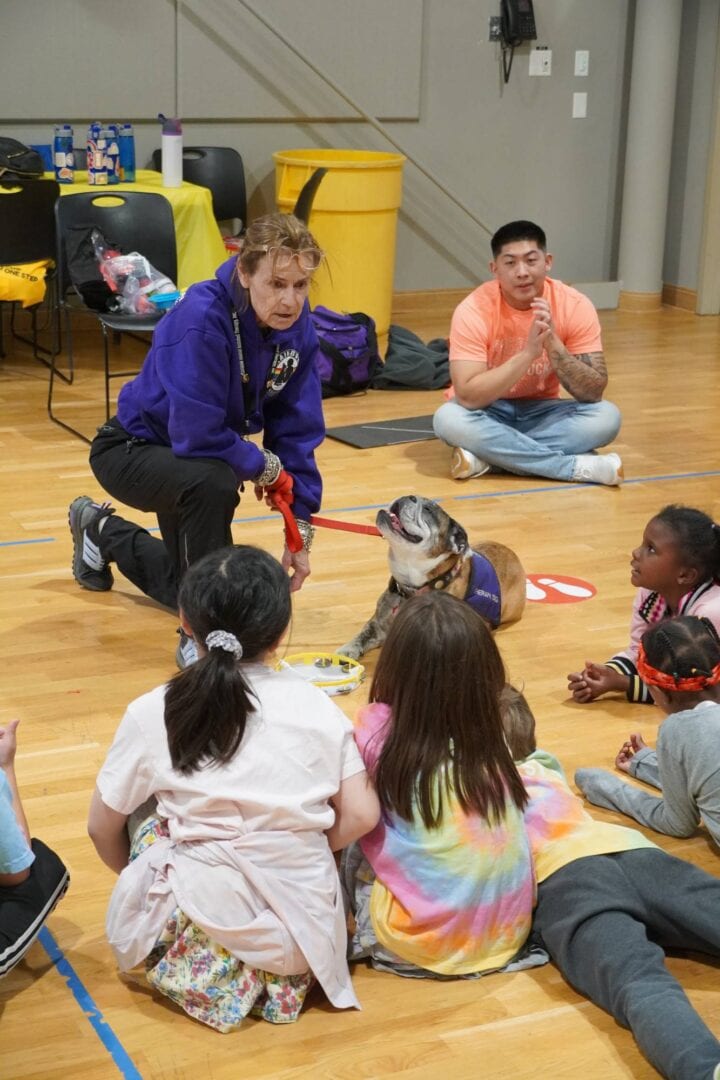 Dog therapy session at Camp One Step for children and volunteers.
