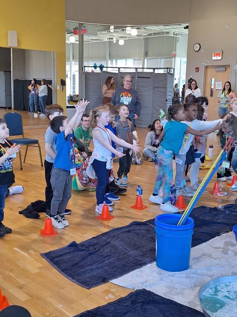 Bright kids participating in fun camp activity indoors.