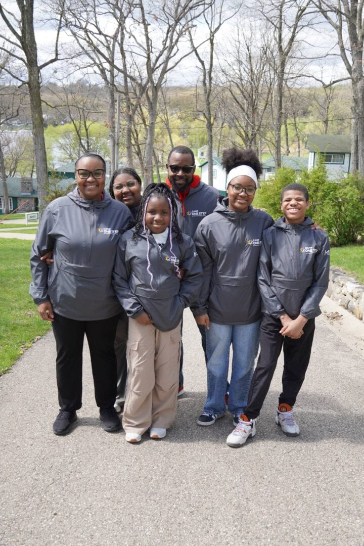 Camp One Step youth and staff outdoor group photo in a park setting.