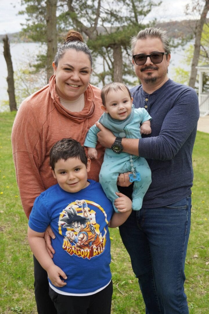 Joyful family at Camp One Step outdoor retreat, enjoying nature and bonding experience.