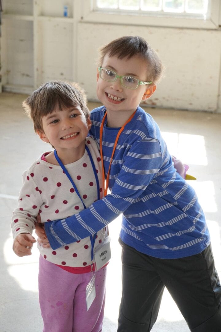 Happy children hugging at Camp One Step, promoting inclusion and support for kids with disabilities.