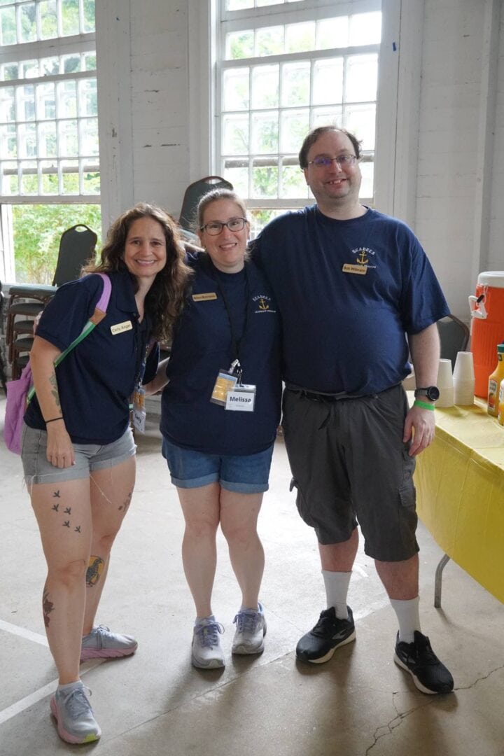 Friendly camp staff at outdoor summer camp event.