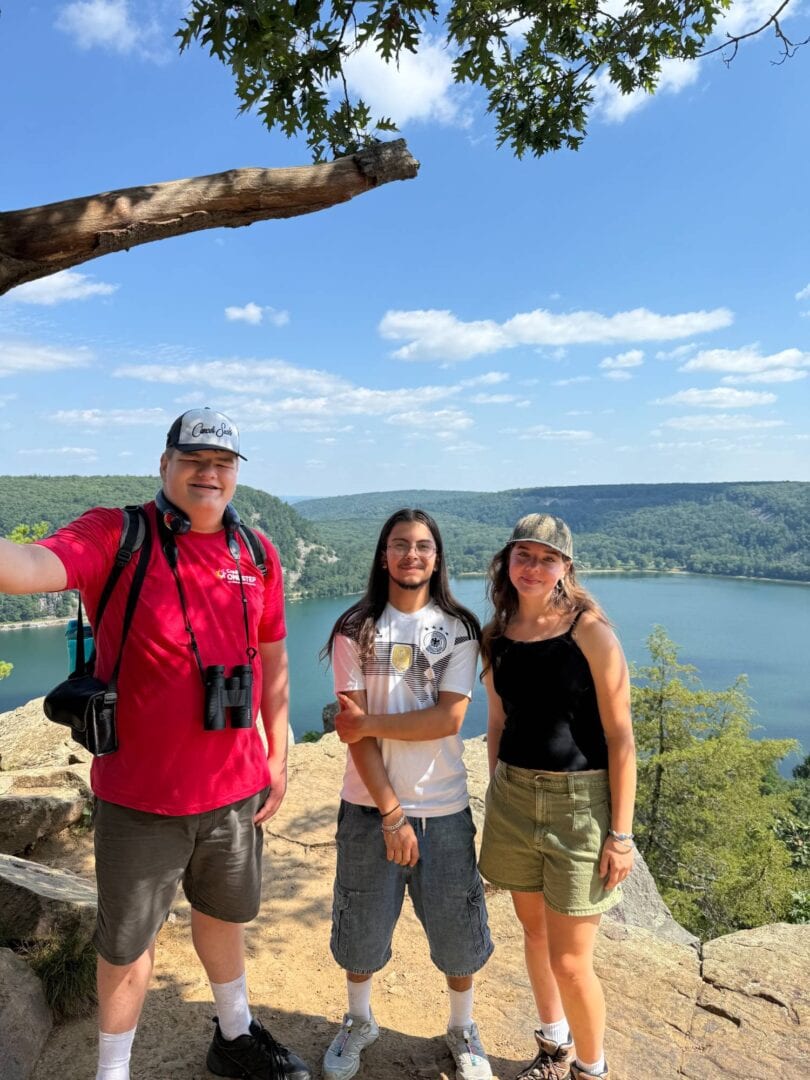 Family enjoying outdoor camping at Camp One Step with panoramic lake view and nature.