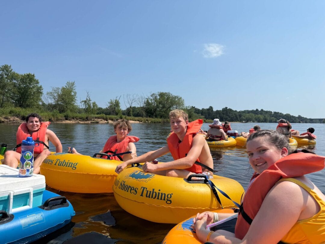 Kids enjoying tubing adventure on the river at Camp One Step.