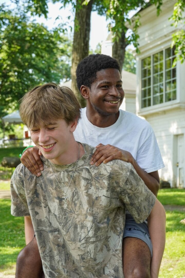 Smiling young people enjoying outdoor activities at Camp One Step's youth camp and outdoor programs.