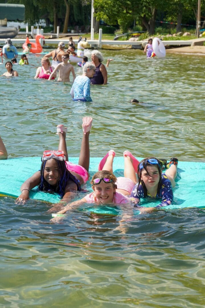 Kids swimming and playing at Camp One Step water park in the summer.