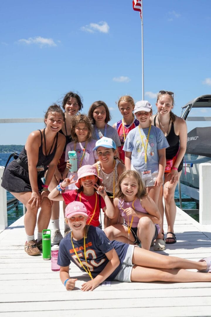 Children enjoying summer camp activities by the water.