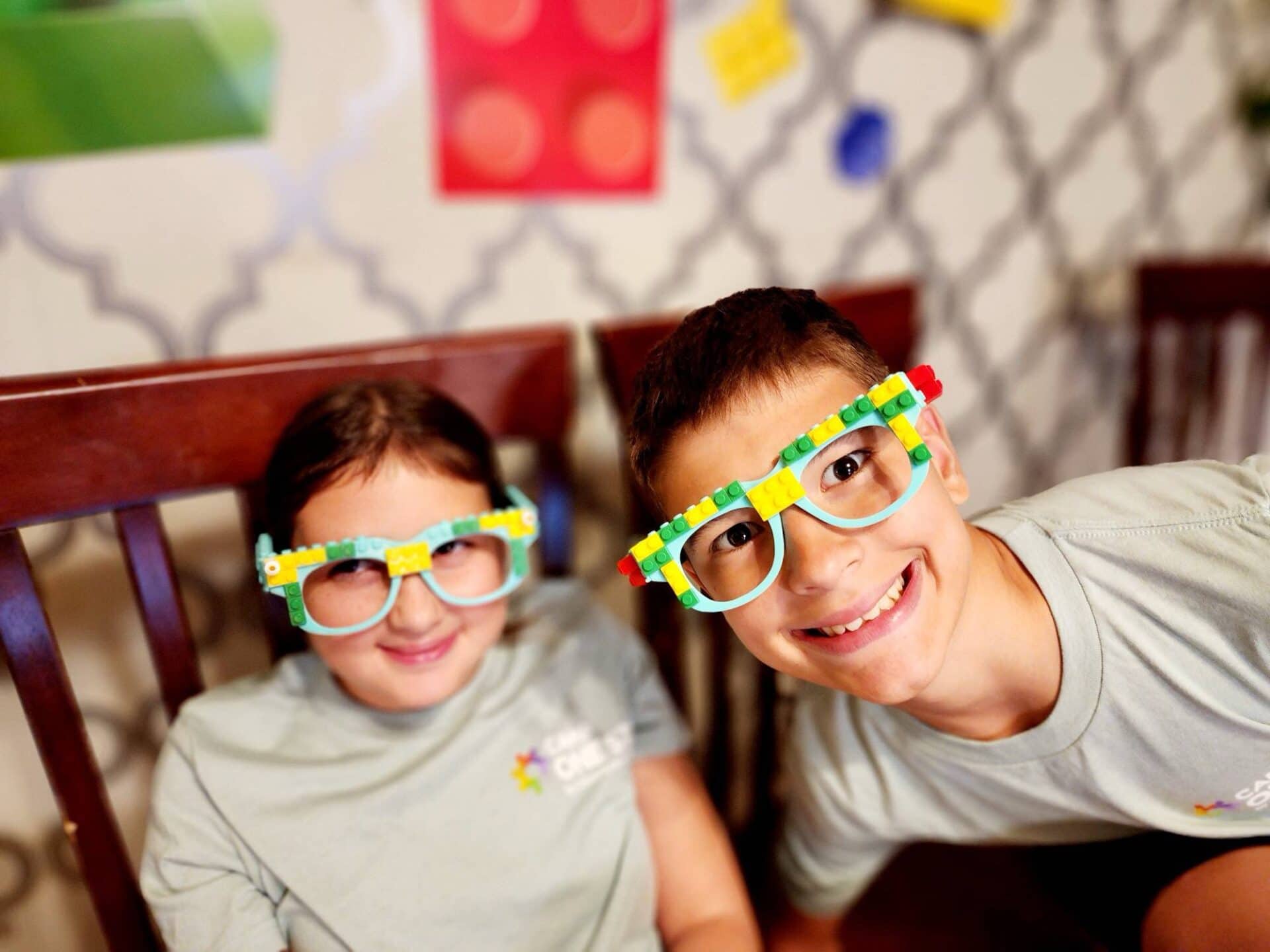 Colorful Lego glasses worn by smiling kids at Camp One Step.