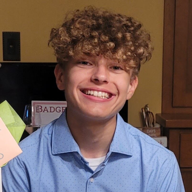 Smiling young man at Camp One Step camp, happy camper, outdoor adventure, youth camp, summer camp activities.