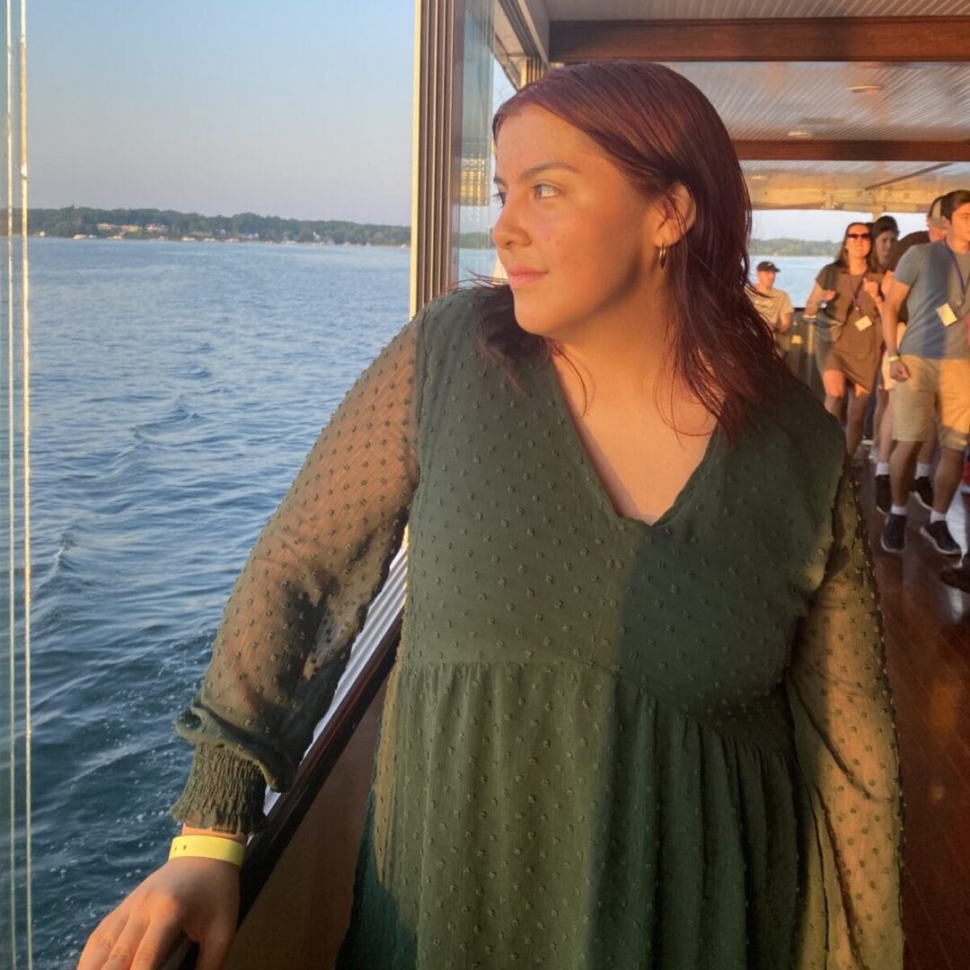 Relaxed woman on boat looking at water during Camp One Step outdoor event.