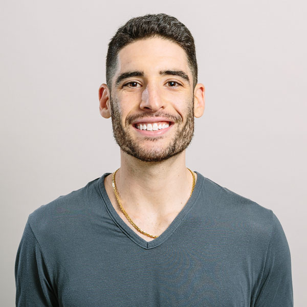 Smiling young man at Camp One Step, embracing community and outdoor activities.