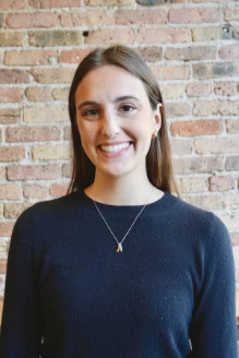 Comfortable young woman smiling at Camp One Step youth program.