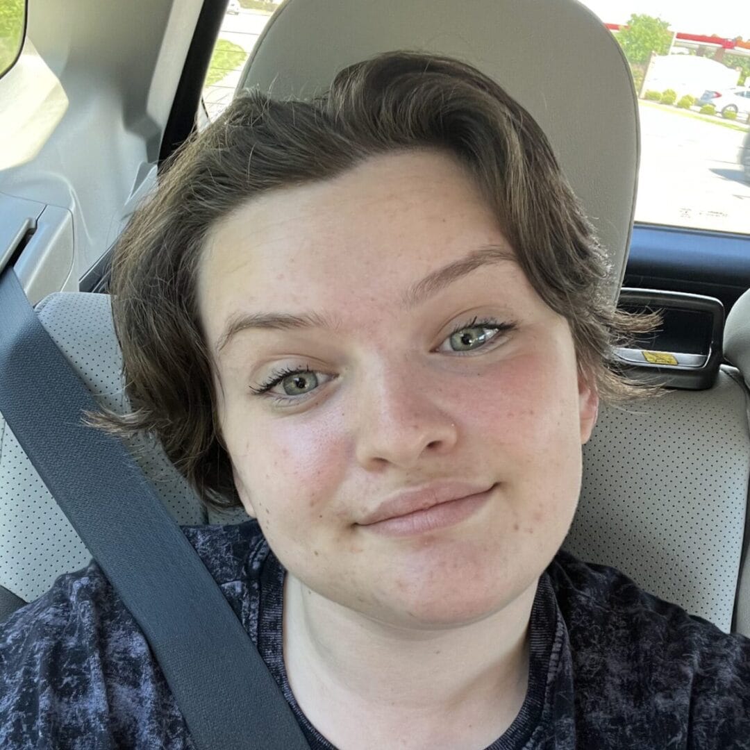 Fresh-faced girl smiling on road trip, enjoying outdoor camping experience, visiting Camp One Step.