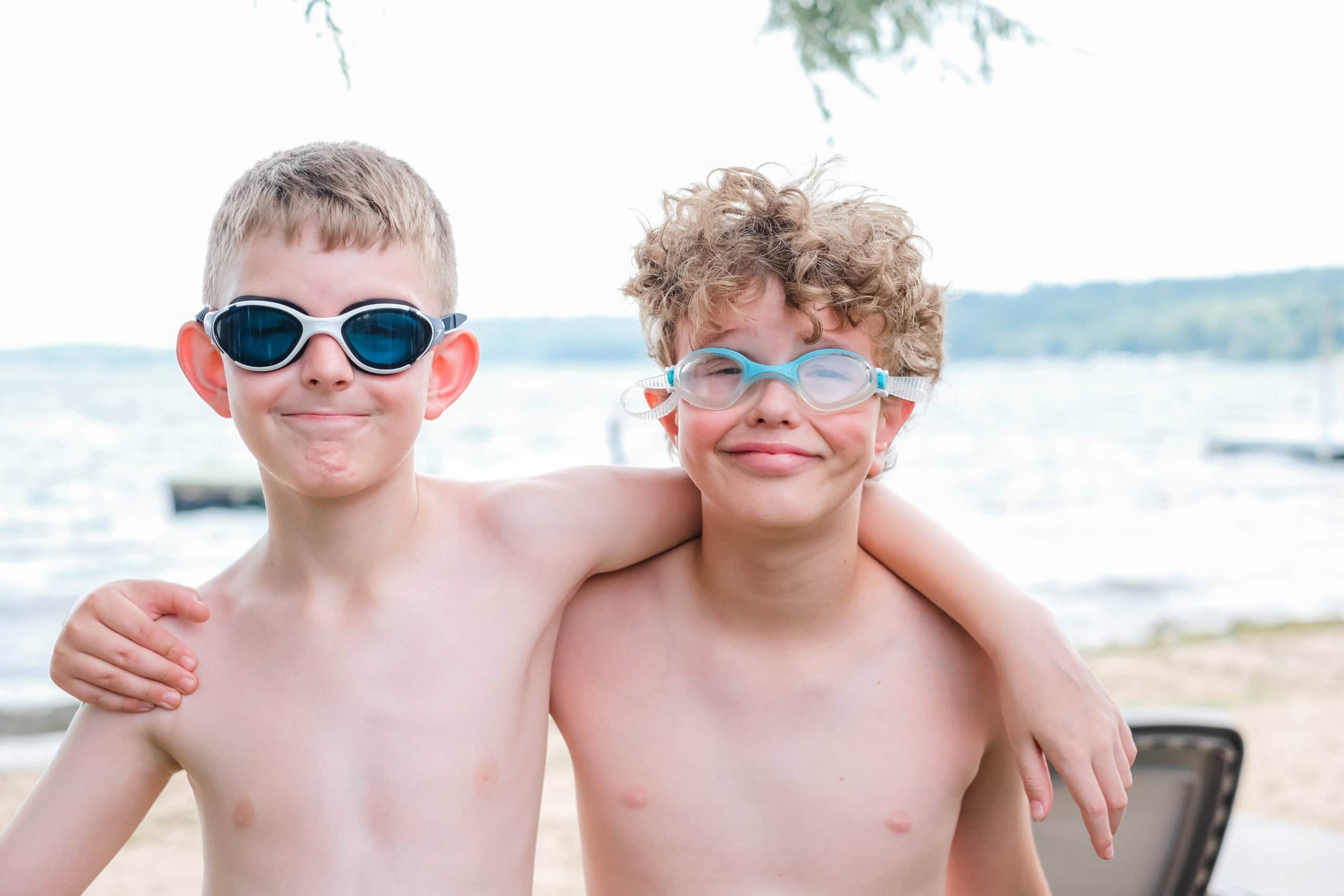 Kids enjoying summer camp at Lake, wearing swimming goggles, smiling, outdoor activity, youth camp, fun days, water sports.