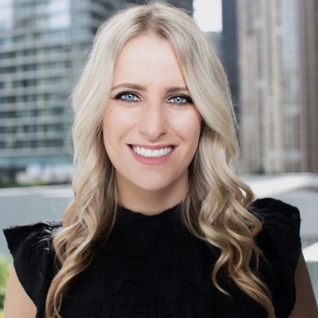 Bright smiling woman outdoors, urban background, representing wellness and confidence.